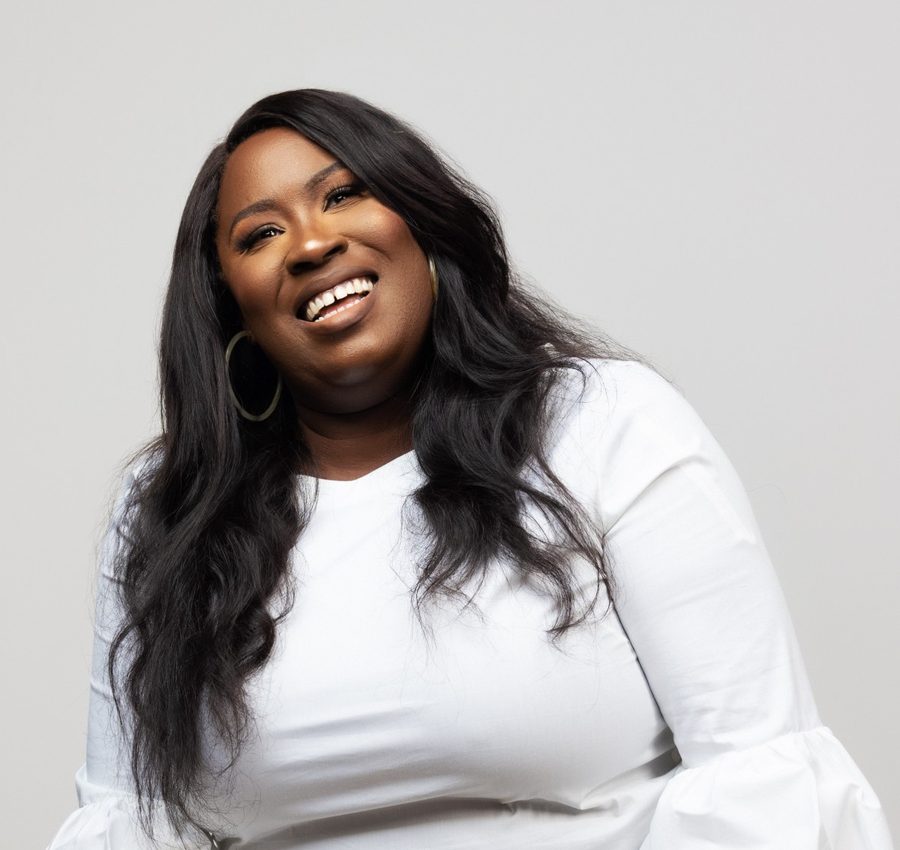 Rhonda Cammon smiling, in a white top against a light grey backdrop